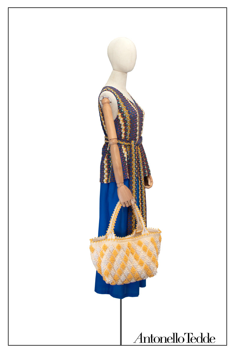 On Model full view of tote with SMALL DIAMONDS ROMBETTI in yellow and cream. The best eco luxury bags and accessories brand. Stylish clothes and Eco-Friendly with recycled yarns