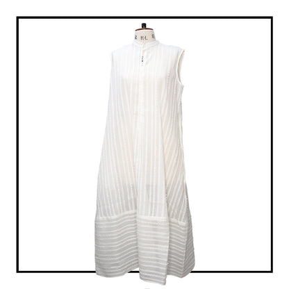 Cream sleeveless dress with a standing collar, crafted from 100% Khadi cotton handwoven in India, featuring a flowing design with hidden pockets and a matching belt for versatile styling.