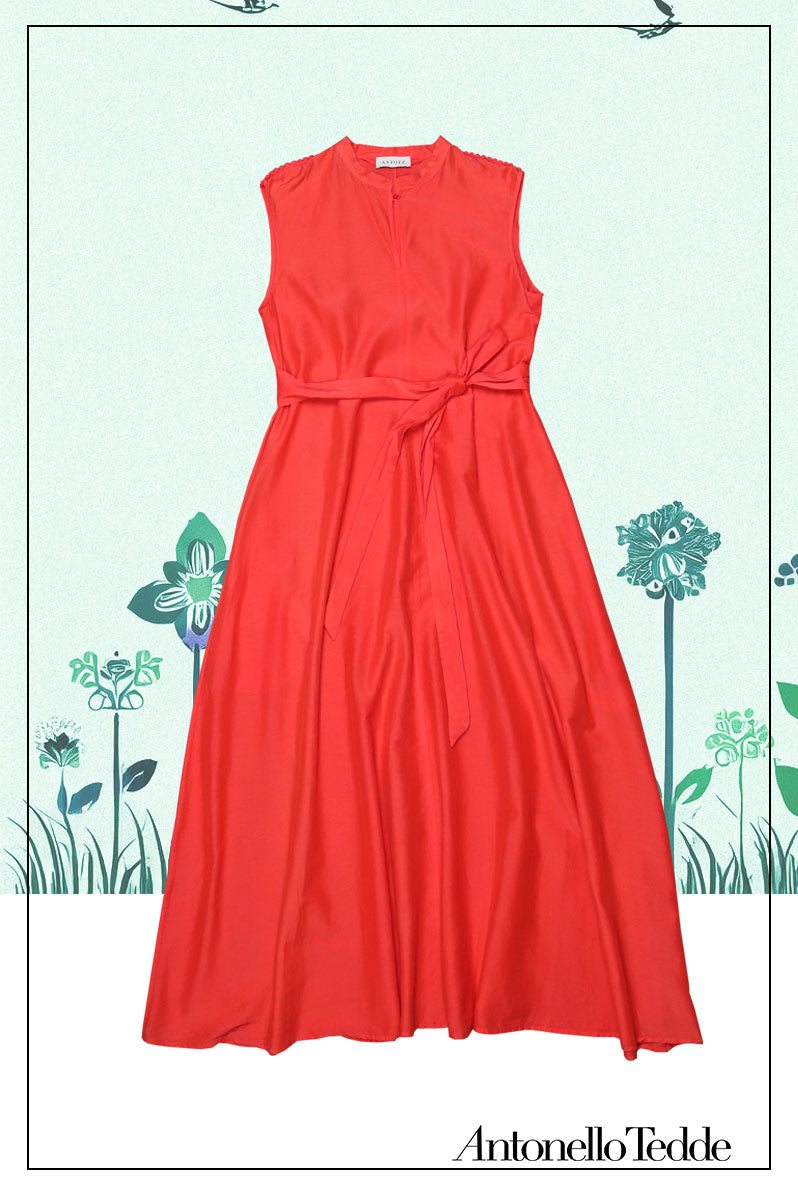 Front view with the belt of an elegant red long sleeveless dress with a standing collar, crafted from 80% cotton and 20% silk, featuring Antonello Tedde's distinctive pom detail design, a flowing silhouette, hidden pockets, and a matching belt for versatile styling.