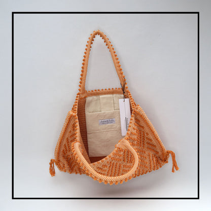 Capriccioli Medium orange with zig zag pattern - The bag is made using authentic Sardinian hand weaving methods in ethically managed factories. This tote bag is extraordinary and evokes faraway cultures with a contemporary touch, with focus on details such as colour, and material that are sustainable and eco-conscious