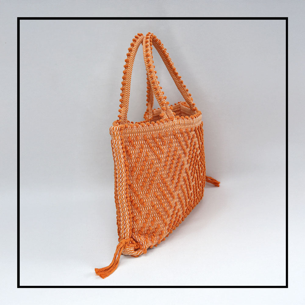 Capriccioli Medium orange with zig zag pattern - The bag is made using authentic Sardinian hand weaving methods in ethically managed factories. This tote bag is extraordinary and evokes faraway cultures with a contemporary touch, with focus on details such as colour, and material that are sustainable and eco-conscious