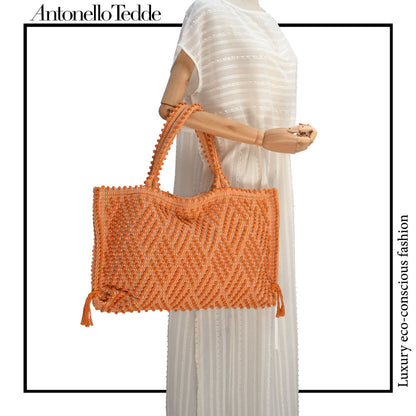 Capriccioli Medium orange with zig zag pattern - The bag is made using authentic Sardinian hand weaving methods in ethically managed factories. This tote bag is extraordinary and evokes faraway cultures with a contemporary touch, with focus on details such as colour, and material that are sustainable and eco-conscious