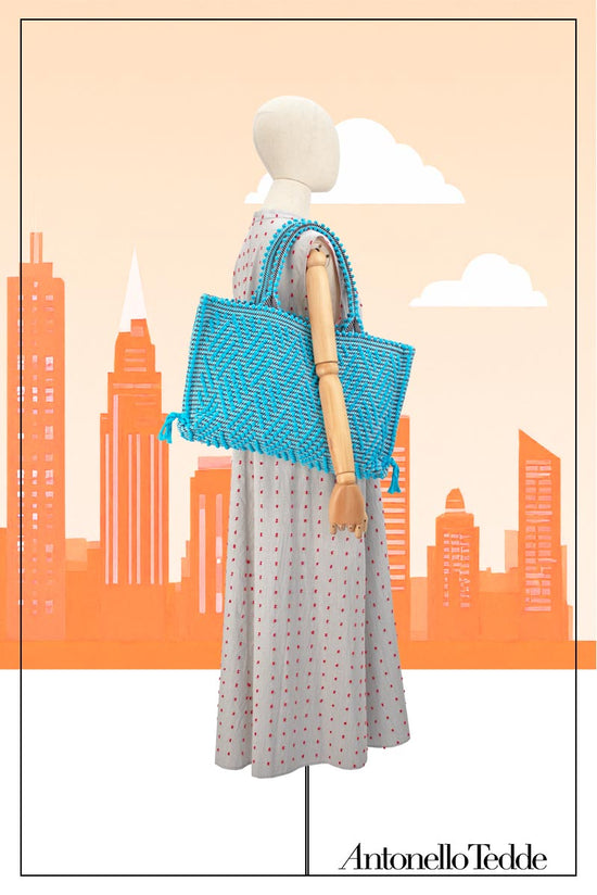 Medium tote bag turquoise and black with diamond pattern on a model for proportions it is a winter or summer bag - luxury handbag - handwoven tote made in Italy by hand • timeless individualistic fashion • eco-friendly fashion • socially responsible, lasting fashion