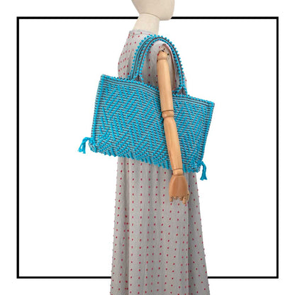 Medium tote bag turquoise and black with diamond pattern on a model for proportions it is a winter or summer bag - luxury handbag - handwoven tote made in Italy by hand • timeless individualistic fashion • eco-friendly fashion • socially responsible, lasting fashion